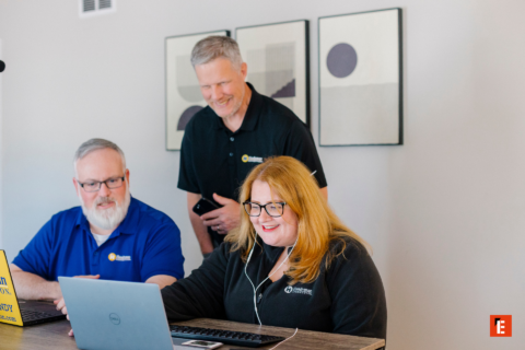 team collaboration around laptops in modern workspace