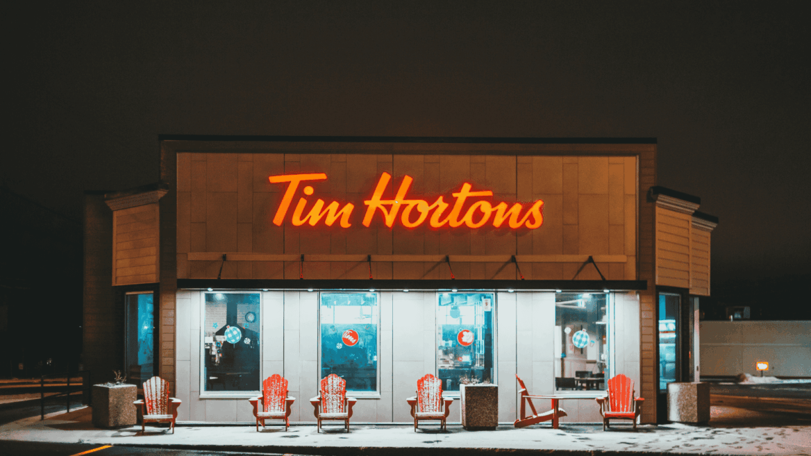 tim hortons at night: neon sign and snowy red chairs