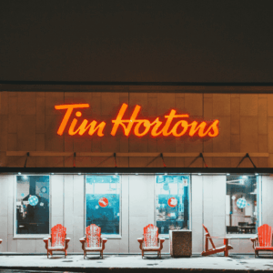 tim hortons at night: neon sign and snowy red chairs