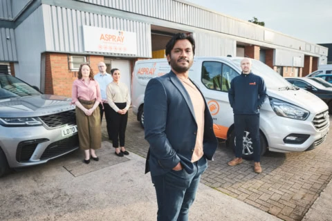 aspray team leader with branded service vans