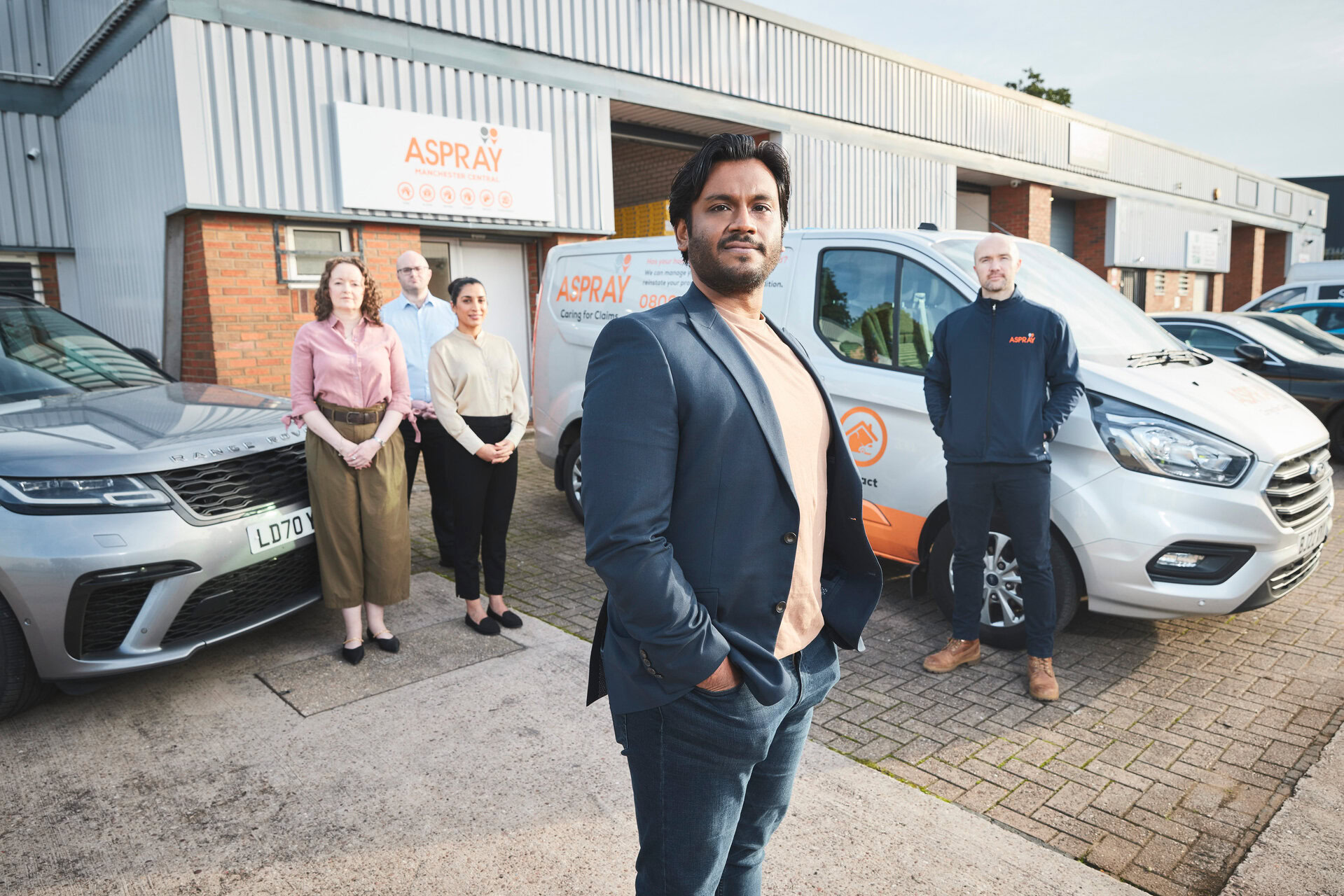 aspray team leader with branded service vans