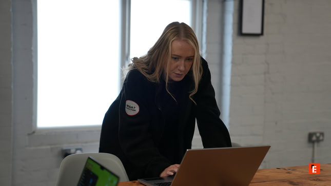 blonde woman working on laptop in bright office