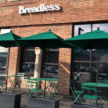 breadless cafe patio with green umbrellas