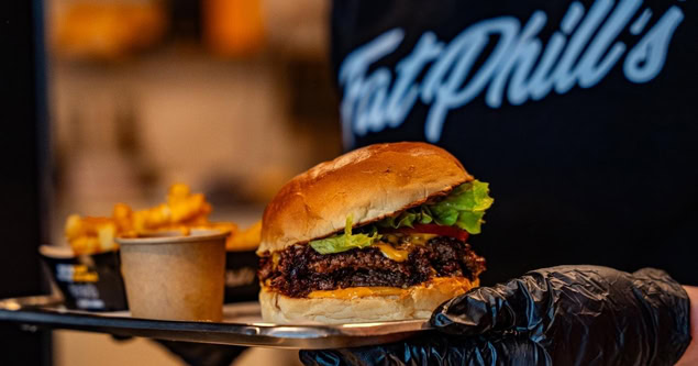 juicy cheeseburger with crinkle fries on tray