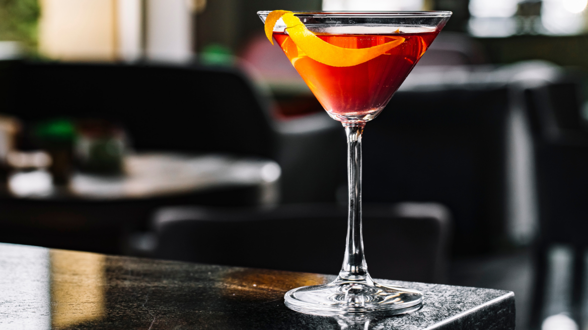 cóctel Ámbar en copa vintage con twist de naranja