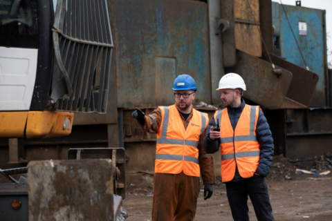 construction workers directing heavy machinery operations