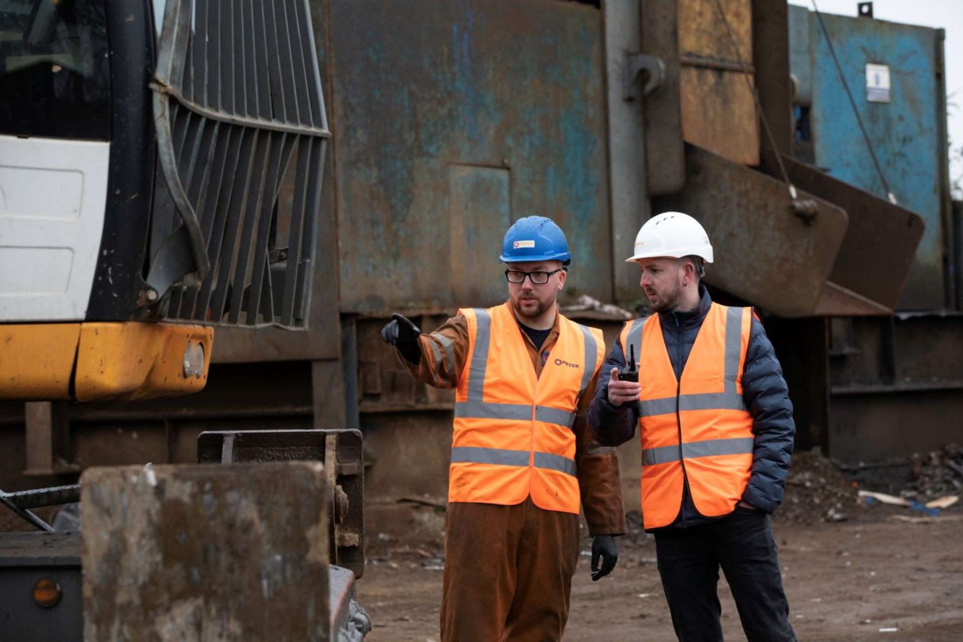 construction workers directing heavy machinery operations