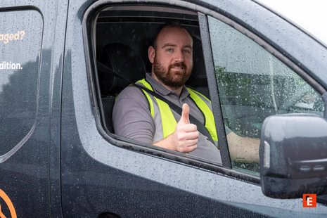 hi vis delivery driver giving thumbs up in van