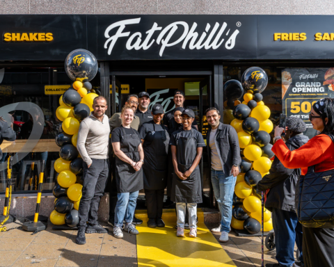 fatphills grand opening with yellow balloons and staff