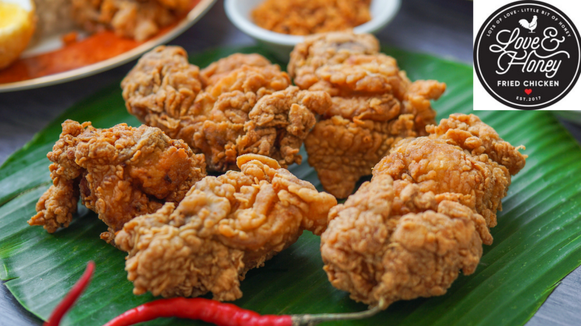 crispy fried chicken on banana leaf with chilies