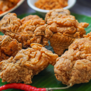 crispy fried chicken on banana leaf with chilies