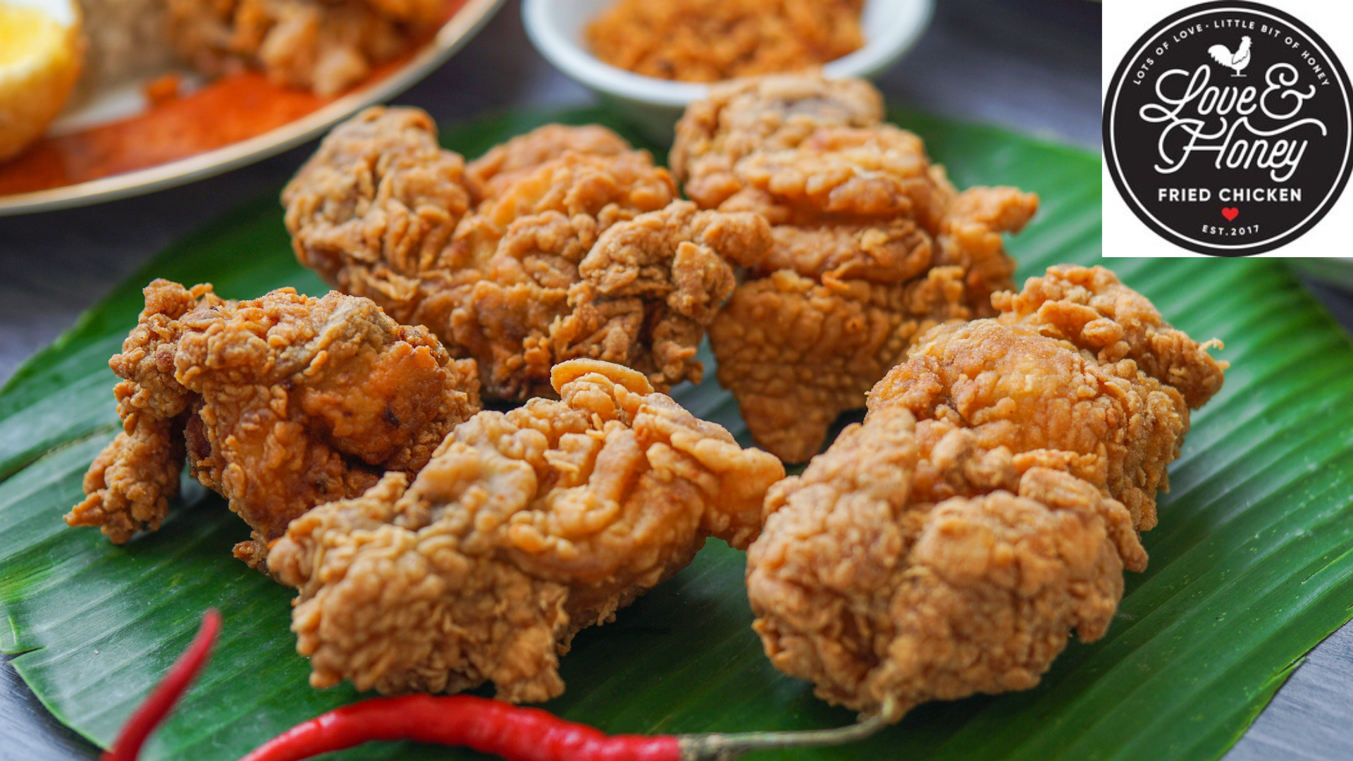 crispy fried chicken on banana leaf with chilies