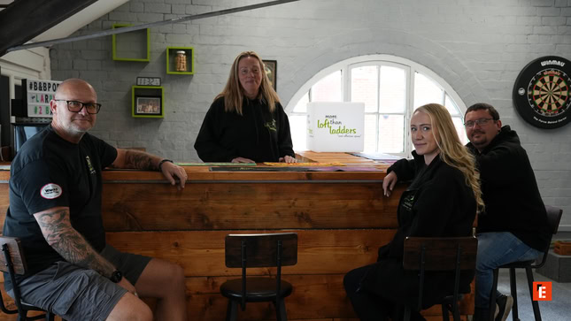 rustic bar group portrait with four adults