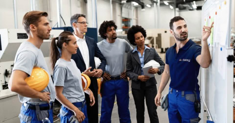 manufacturing team briefing on the factory floor