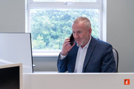 focused business executive on phone in modern office