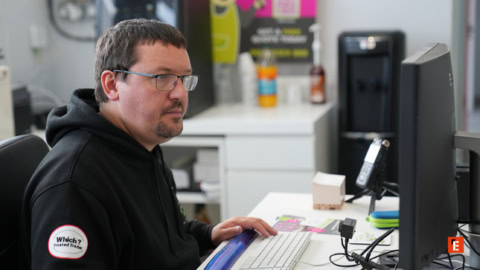 man working at office computer desk