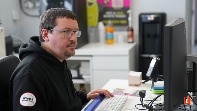 man working at office computer desk