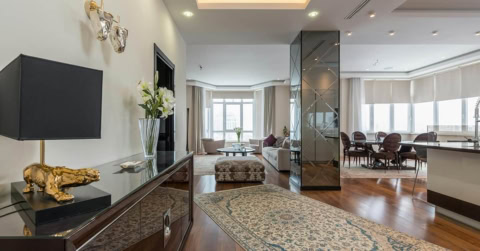 modern living room with mirrored entry and bay window