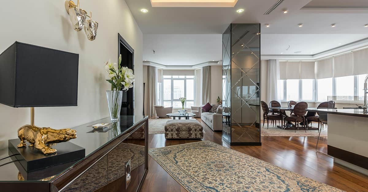 modern living room with mirrored entry and bay window