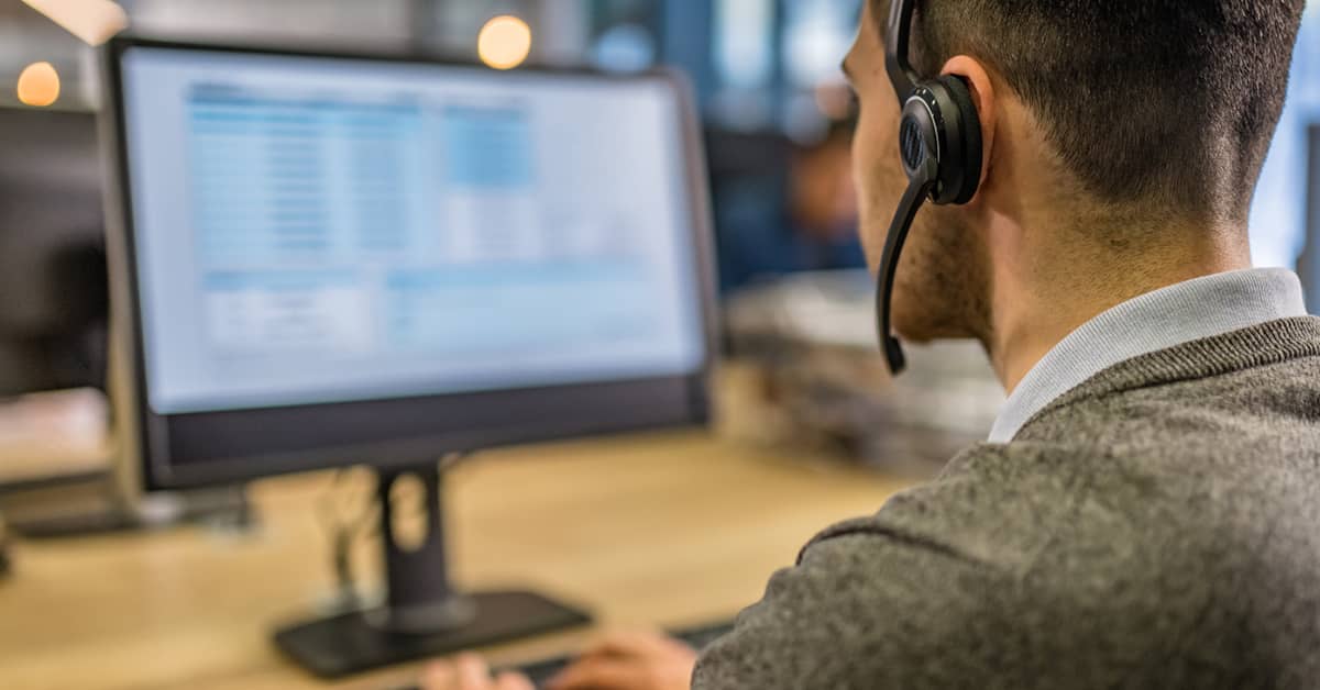 customer support agent at computer monitor
