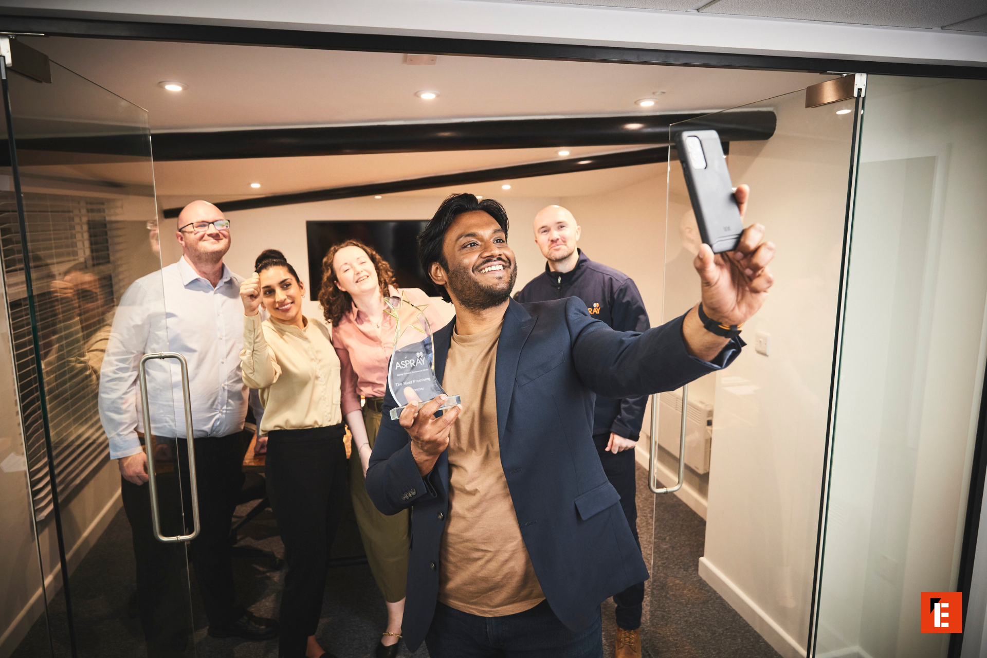 office team celebrates award with selfie