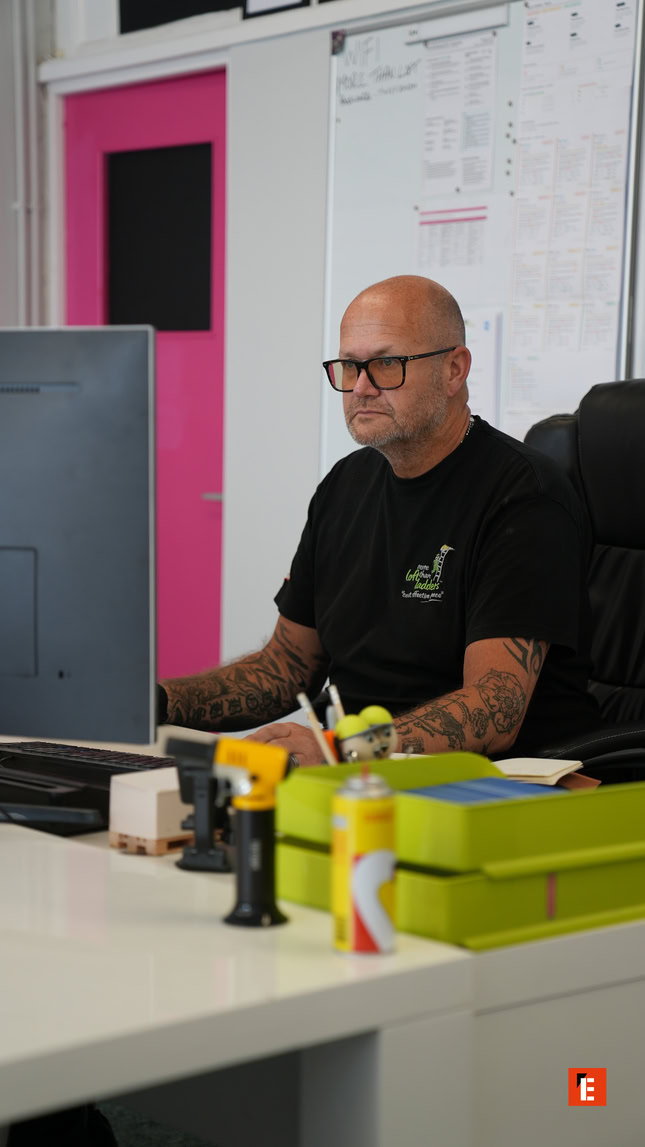 tattooed office worker focused at his desk