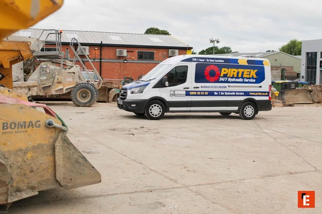 pirtek 24/7 hydraulic service van among heavy equipment