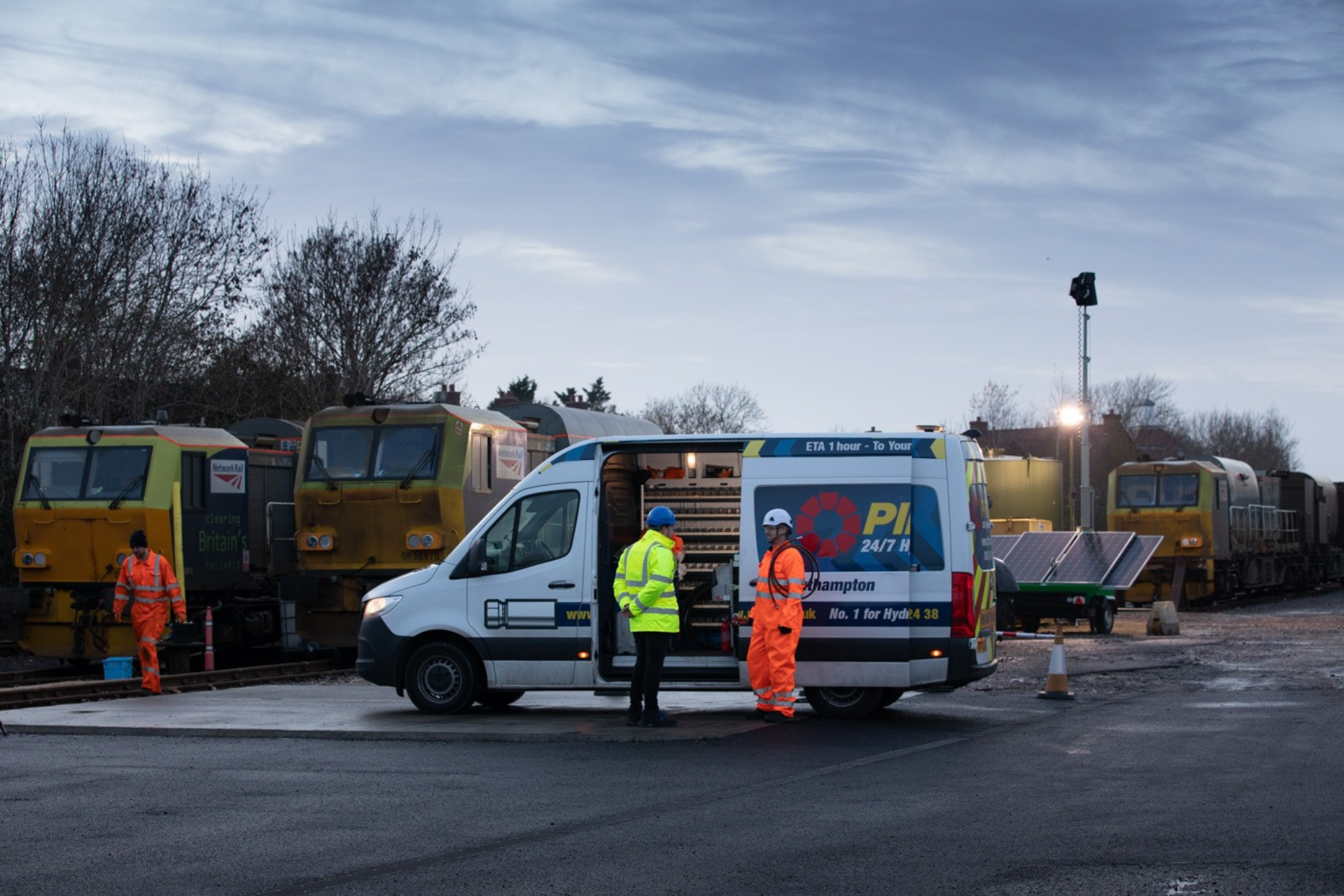 rail yard maintenance at dusk with service van