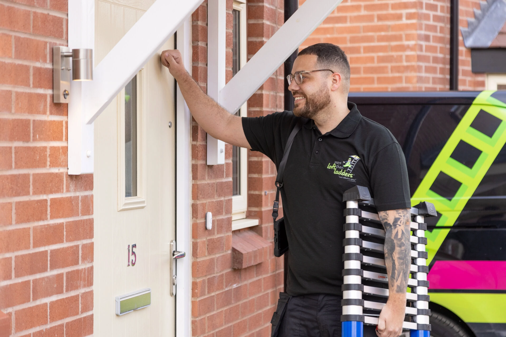 friendly technician knocking at front door with ladder