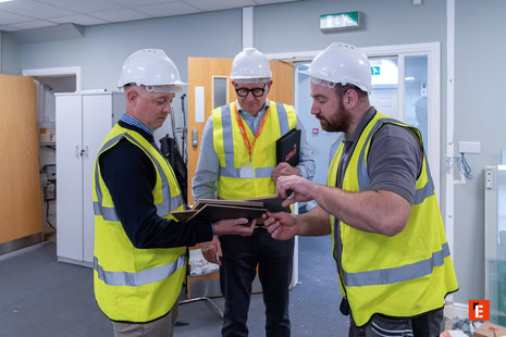 site inspection: team reviewing plans on tablet