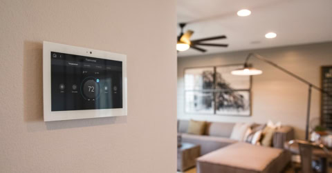 wall mounted touchscreen thermostat in living room