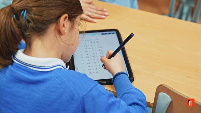 student solving math on tablet in classroom