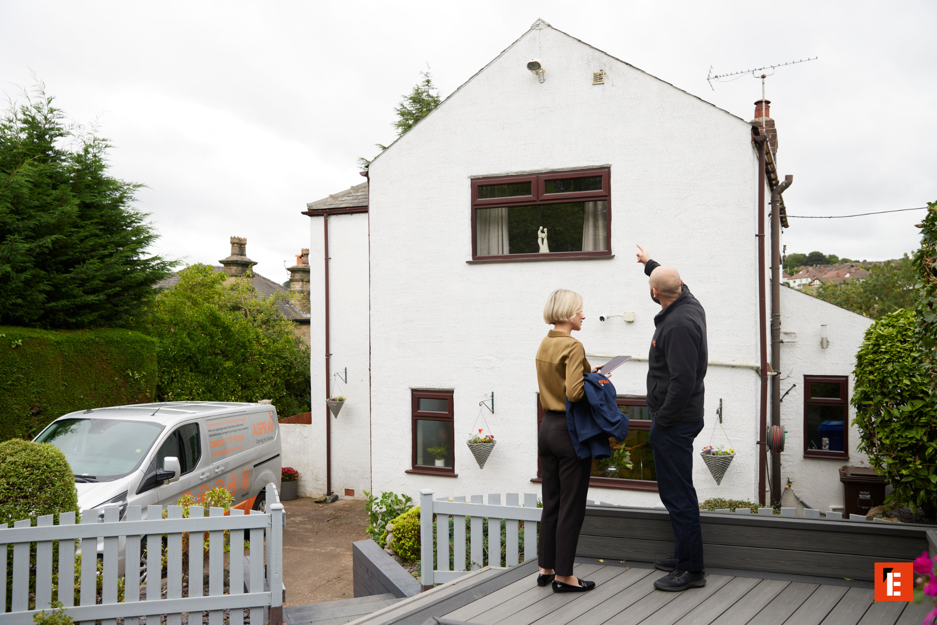 suburban home inspection with inspector and tablet