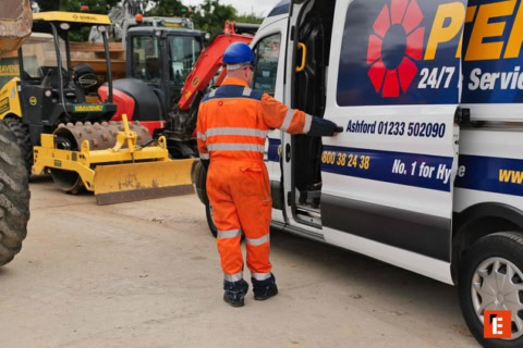 hi vis worker at service van with mini excavator