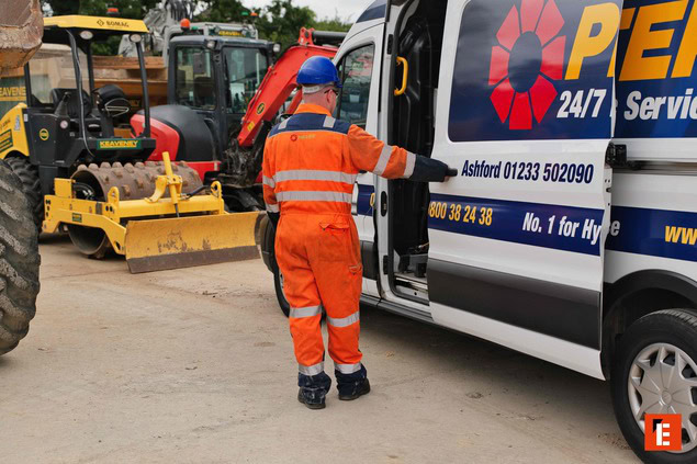 hi vis worker at service van with mini excavator