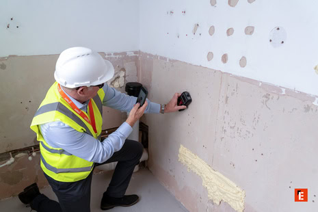 inspector using wall scanner during renovation