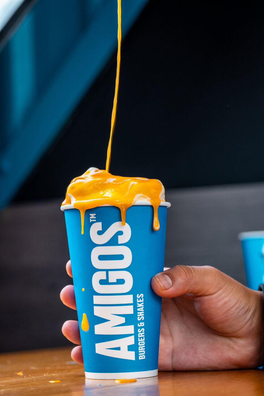 blue paper cup dripping syrupy orange sauce