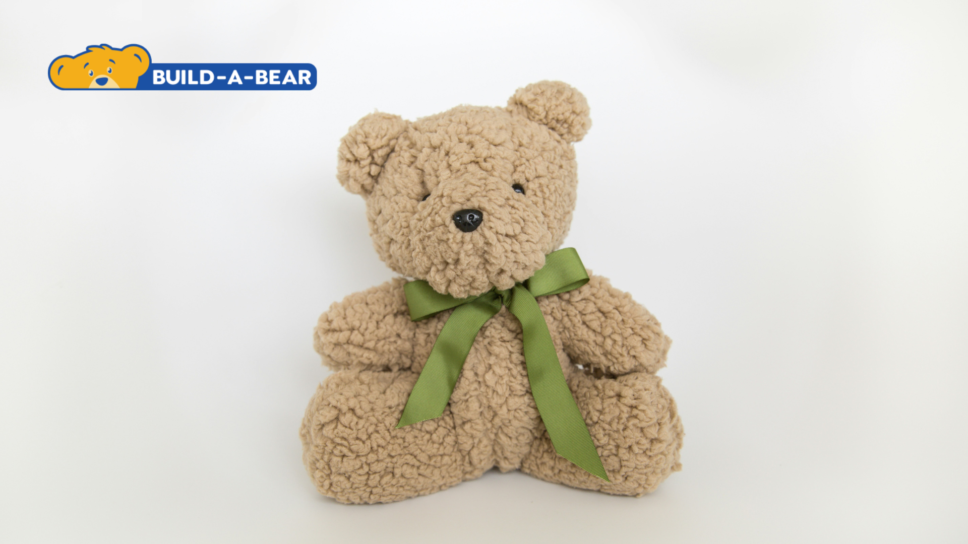 build a bear tan sherpa teddy with green ribbon
