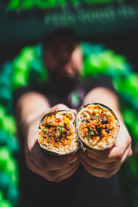 handheld burrito halves with rice, beans & corn