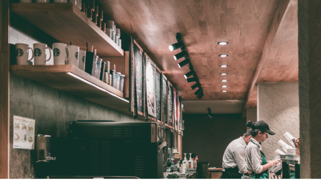 warm wood cafe counter with baristas