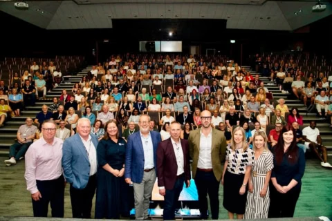 conference speakers and audience in modern auditorium
