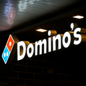 dominos backlit storefront sign at night