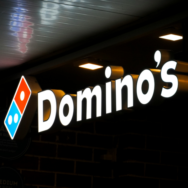 dominos backlit storefront sign at night