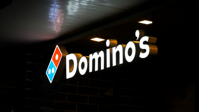 dominos backlit storefront sign at night