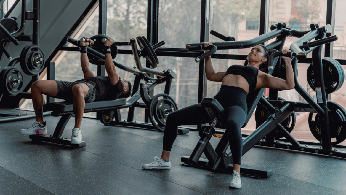 paired chest press workout in sunlit gym