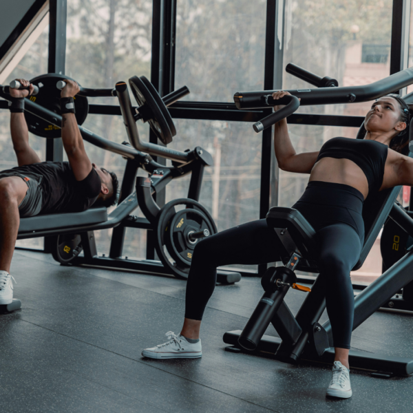 paired chest press workout in sunlit gym