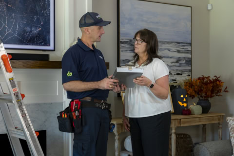 home inspection technician reviewing job with homeowner