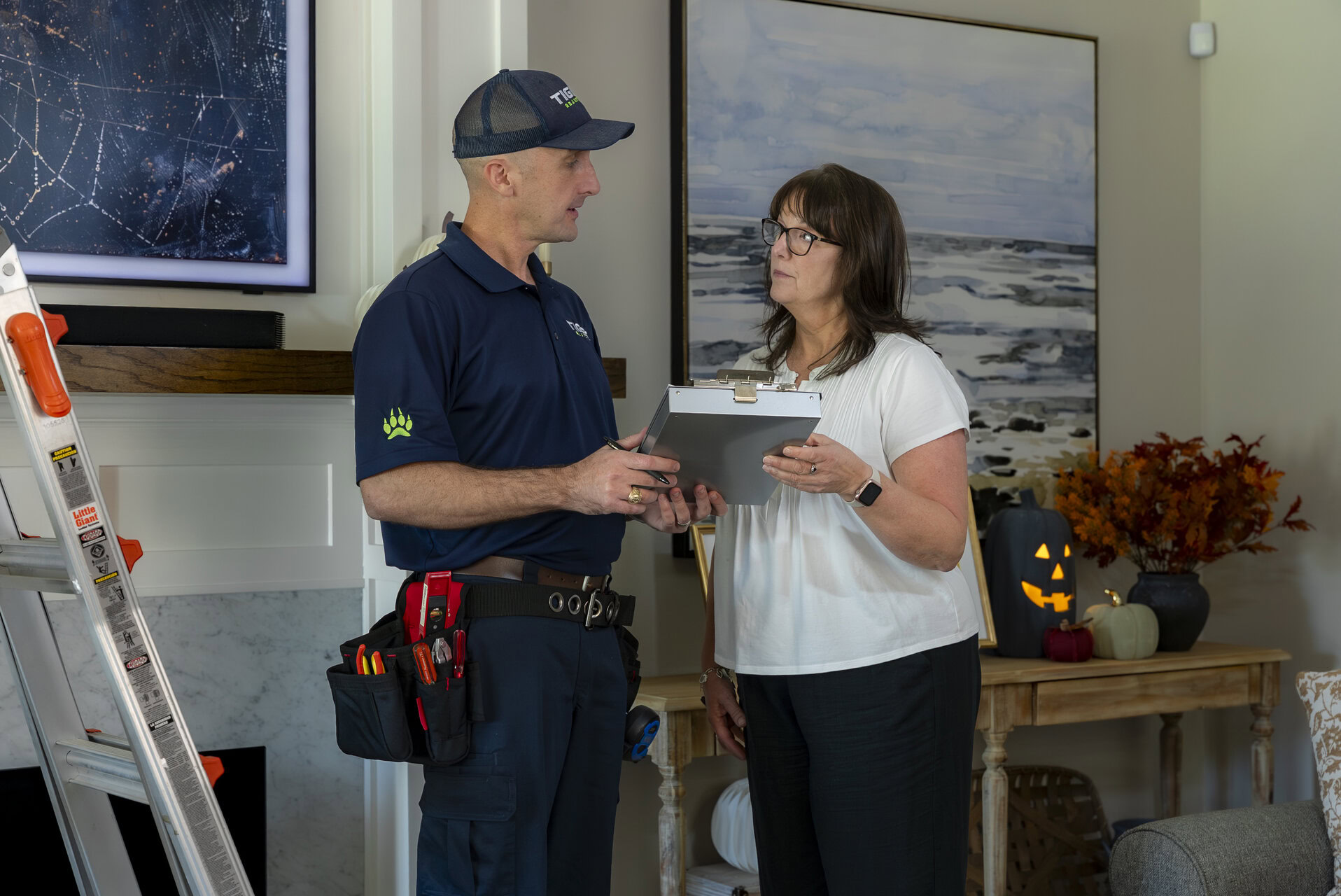 home inspection technician reviewing job with homeowner