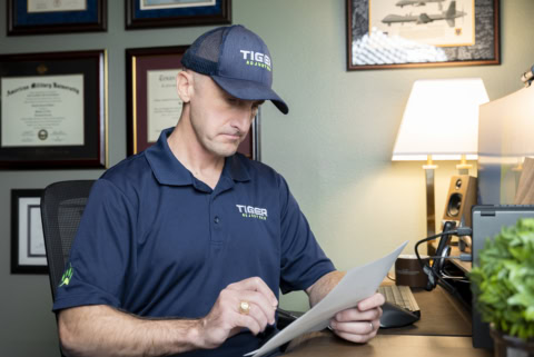 claims adjuster reviewing documents in home office