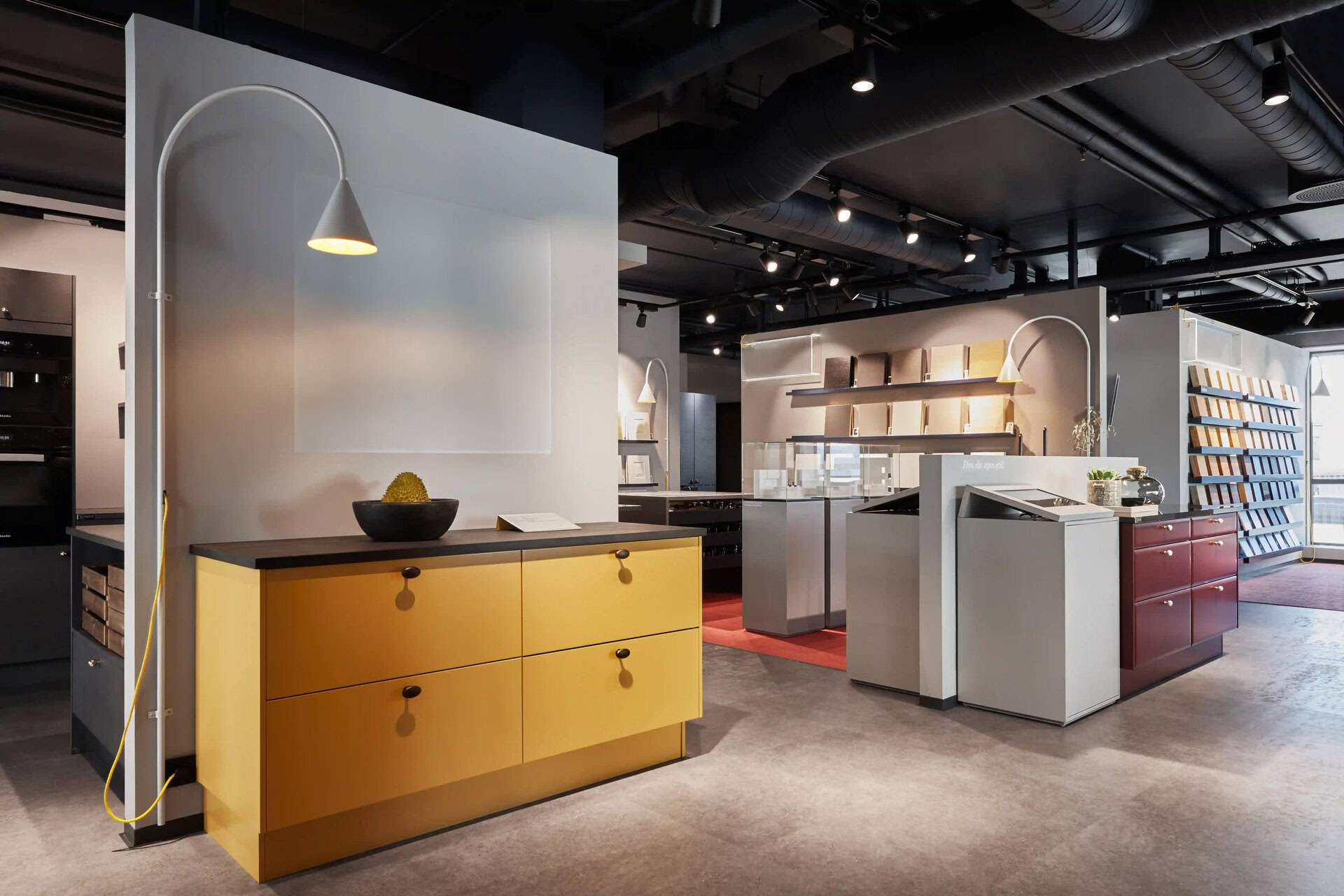 modern kitchen showroom with mustard cabinetry